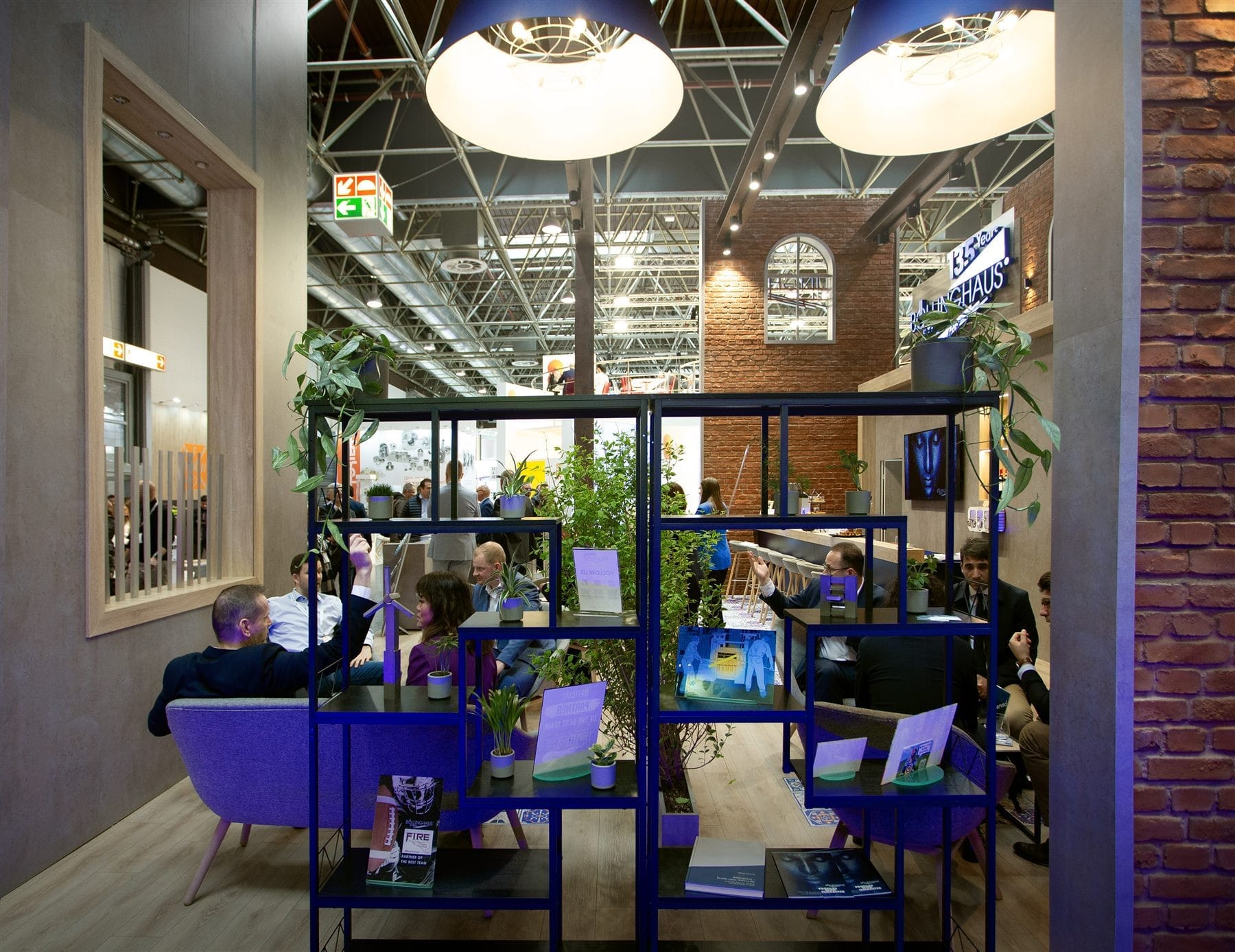 Loungebereich am Böllinghaus-Stand auf der Tube & Wire 2024 mit Backstein und Messinglicht